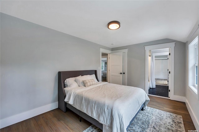 bedroom with lofted ceiling and dark wood-type flooring