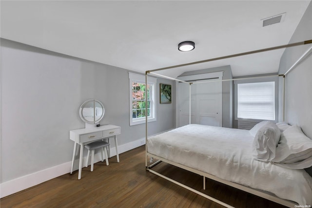 bedroom with dark wood-type flooring