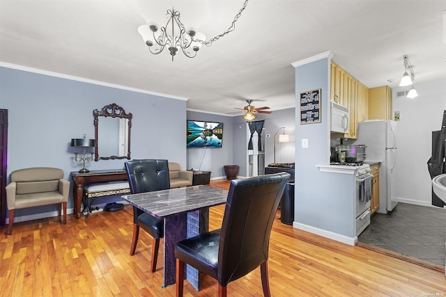 dining space featuring ceiling fan with notable chandelier, crown molding, and light hardwood / wood-style flooring