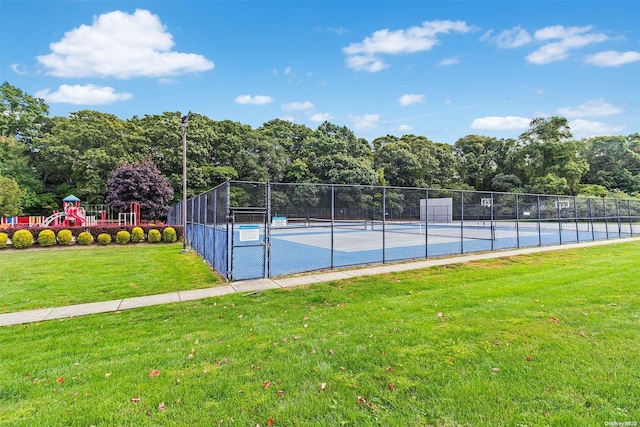 view of sport court featuring a playground and a lawn