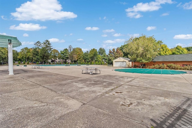 view of pool with a garage and an outdoor structure