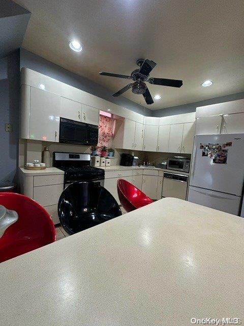 kitchen featuring white cabinets, appliances with stainless steel finishes, a textured ceiling, and ceiling fan