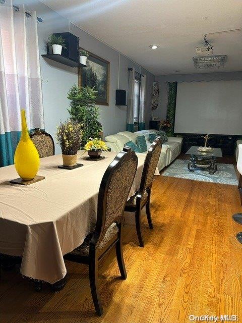 dining space with hardwood / wood-style floors