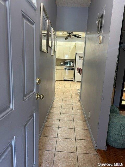 hallway featuring light tile patterned floors