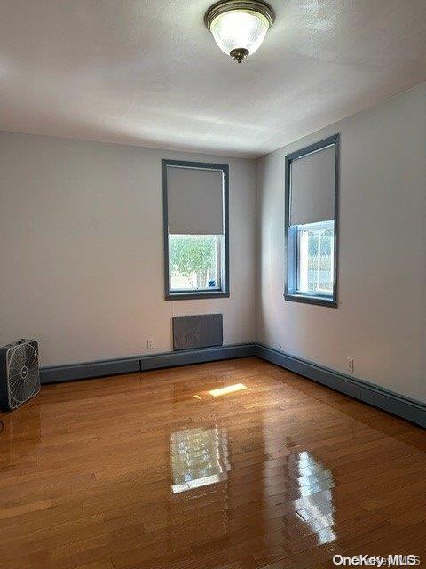 unfurnished room featuring hardwood / wood-style floors