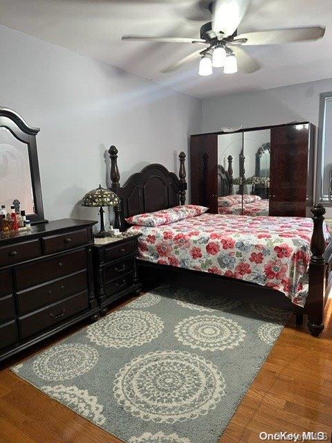 bedroom featuring wood-type flooring and ceiling fan