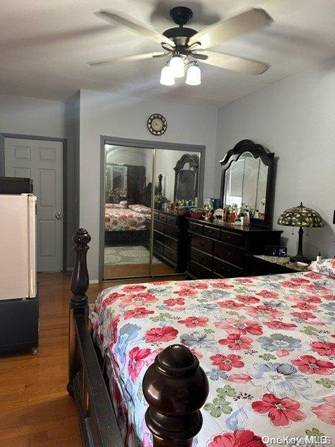 bedroom featuring hardwood / wood-style floors and ceiling fan