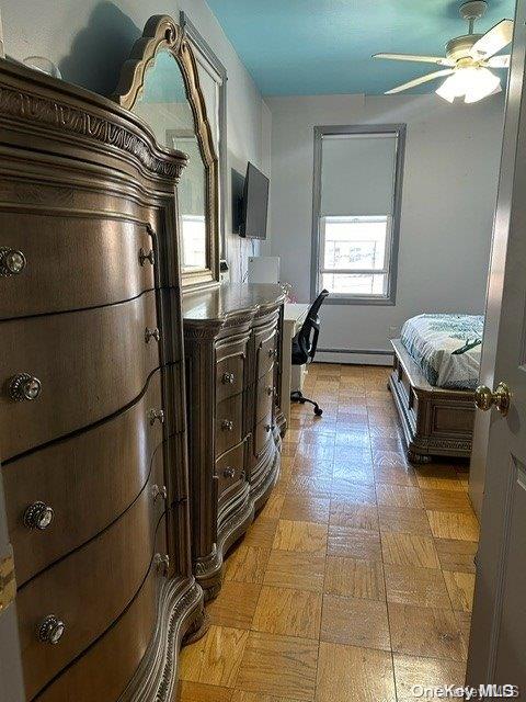 bedroom featuring ceiling fan and baseboard heating