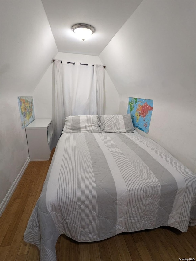 bedroom featuring wood-type flooring and lofted ceiling