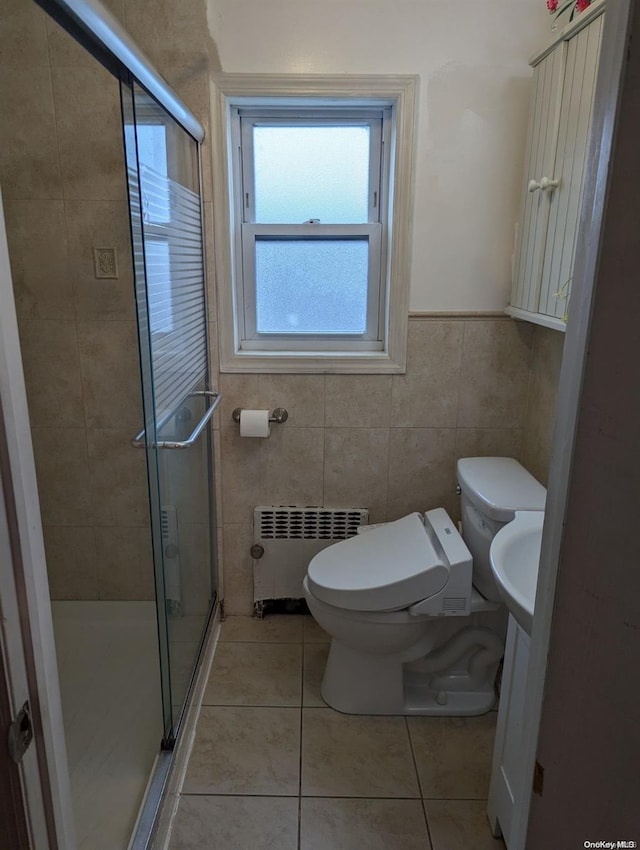 bathroom featuring walk in shower, toilet, radiator heating unit, and tile patterned flooring