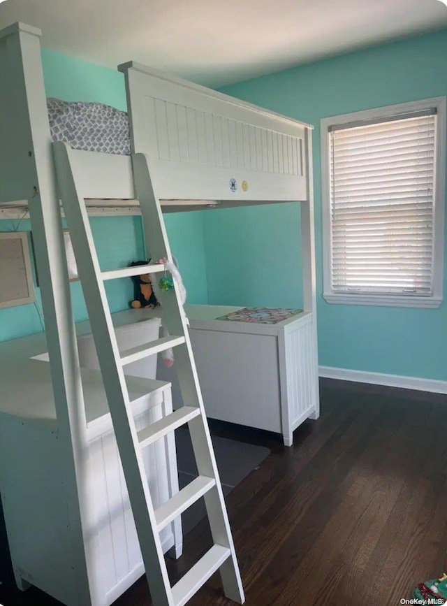 unfurnished bedroom featuring dark hardwood / wood-style floors