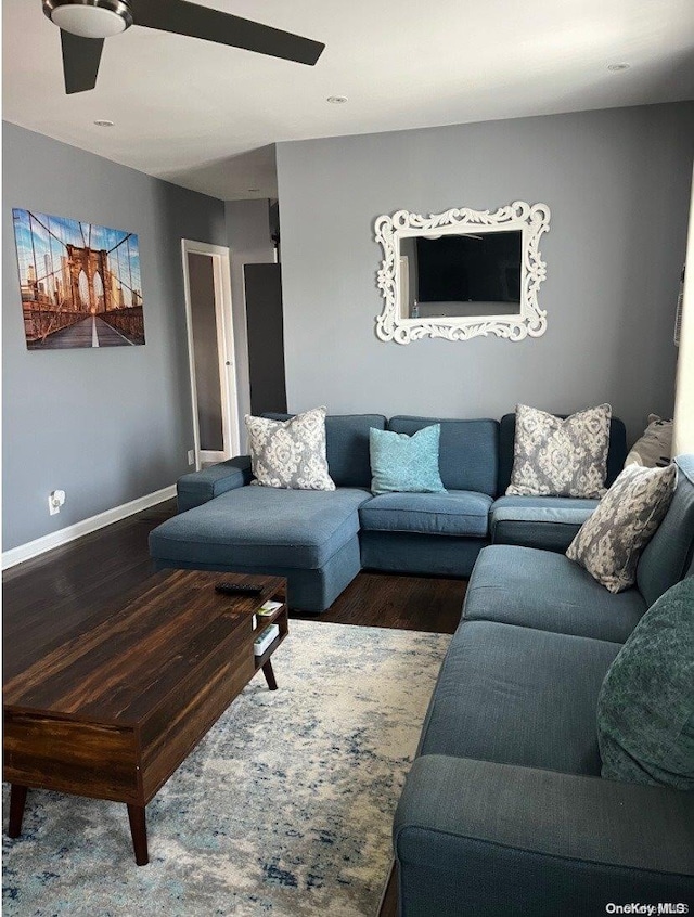 living room featuring hardwood / wood-style floors and ceiling fan