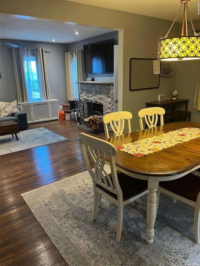 dining room featuring radiator and dark hardwood / wood-style floors