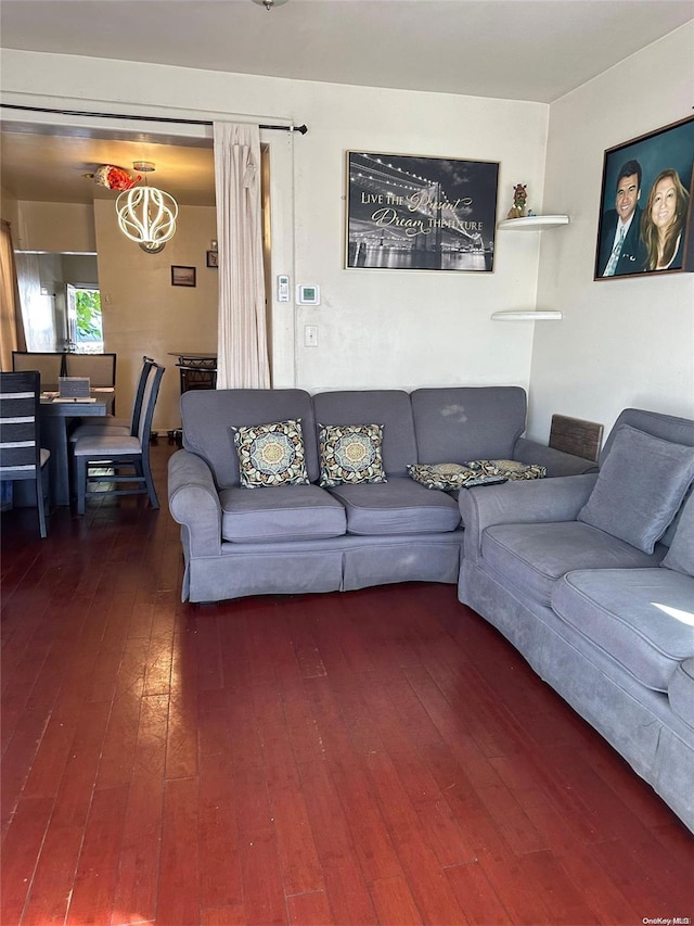 living room featuring an inviting chandelier and hardwood / wood-style flooring