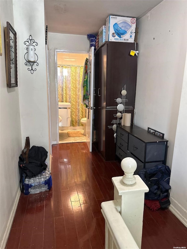 corridor featuring dark hardwood / wood-style floors