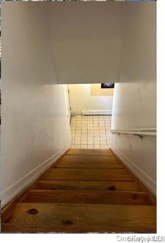 stairs featuring hardwood / wood-style floors