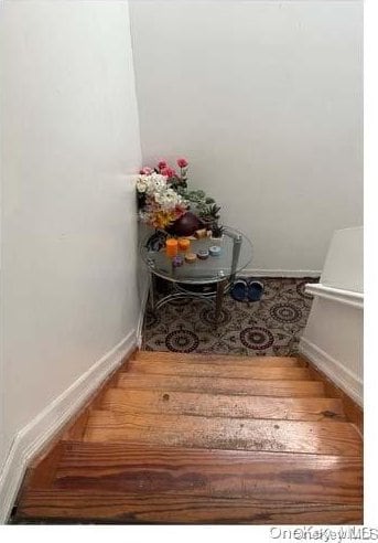 stairs featuring hardwood / wood-style flooring