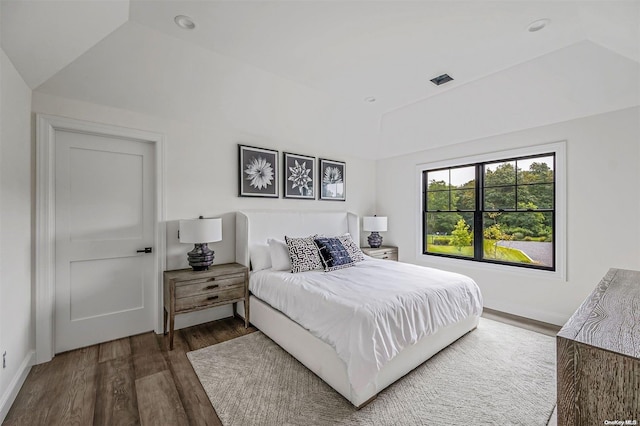 bedroom with lofted ceiling and dark wood-type flooring