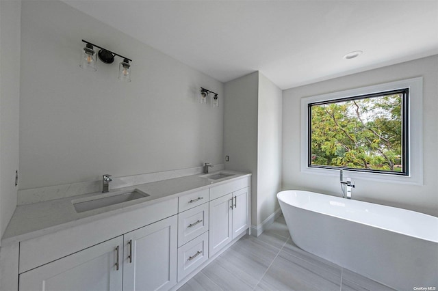 bathroom with vanity and a bath