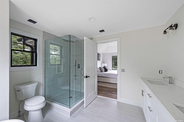 bathroom featuring tile patterned floors, vanity, toilet, and walk in shower