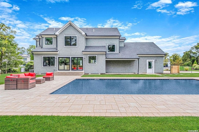 rear view of property featuring an outdoor living space and a patio area