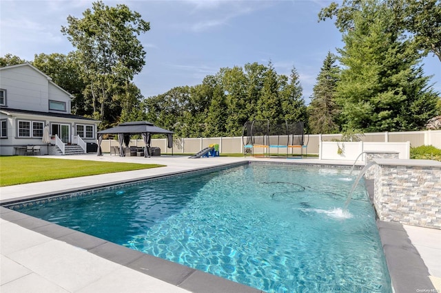 view of pool featuring a gazebo, pool water feature, a yard, and a patio