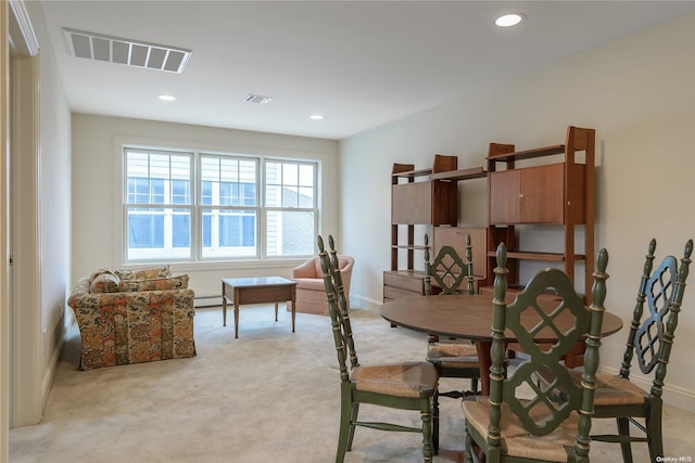 carpeted dining space featuring a baseboard radiator