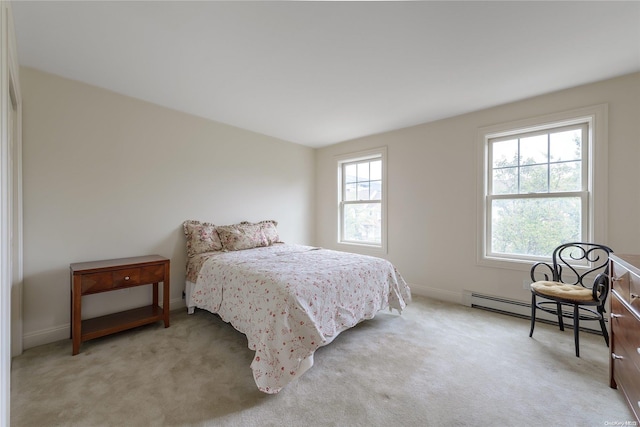 carpeted bedroom with a baseboard heating unit