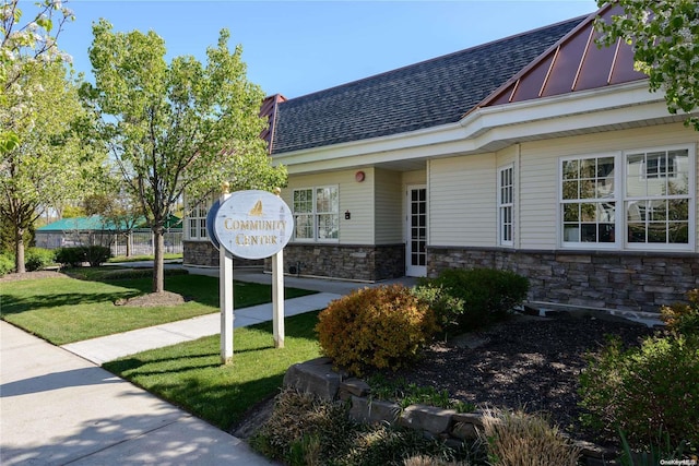 view of exterior entry featuring a lawn