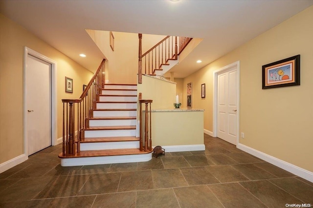 stairway with tile patterned flooring