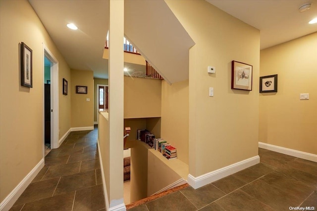 hallway with dark tile patterned floors