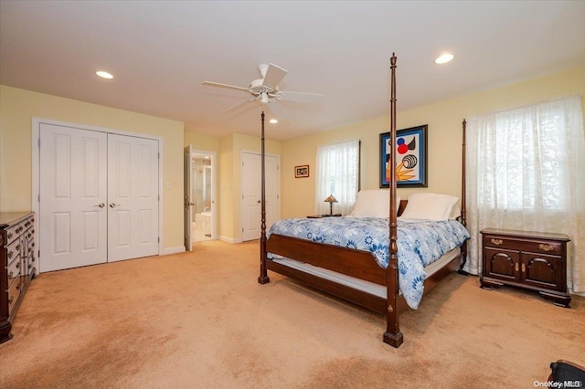 carpeted bedroom featuring connected bathroom and ceiling fan