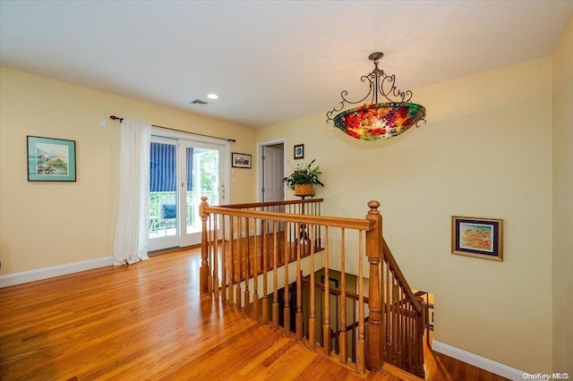 stairs with hardwood / wood-style floors