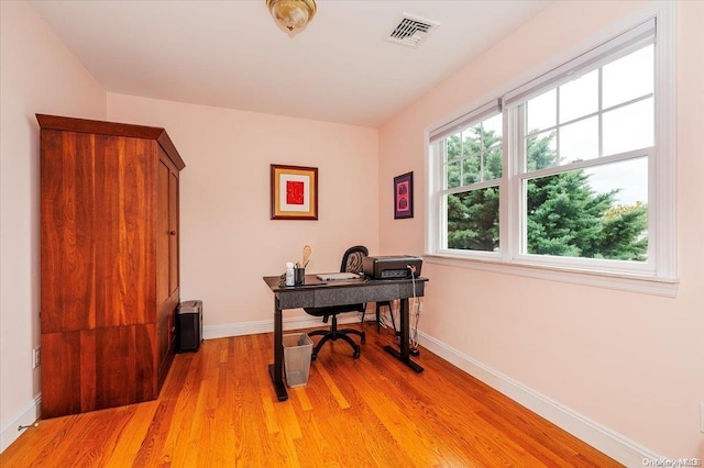 office area with light wood-type flooring and a wealth of natural light