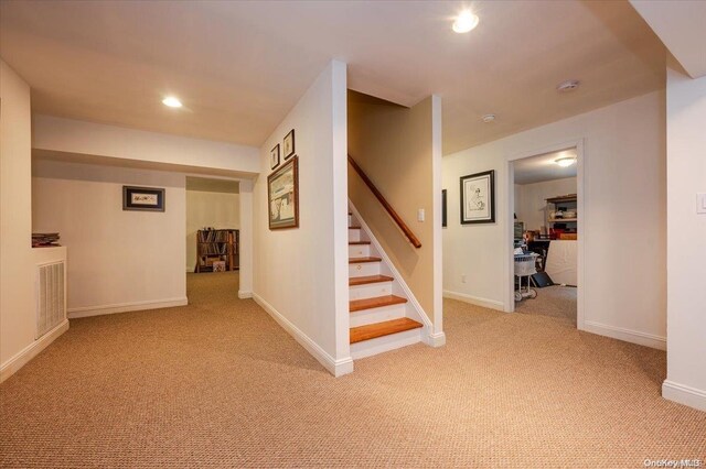 interior space featuring light carpet