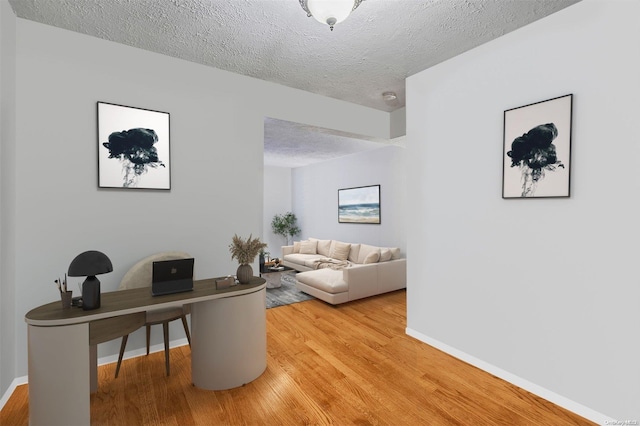 office space featuring light hardwood / wood-style floors and a textured ceiling