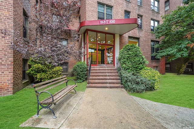 entrance to property featuring a yard