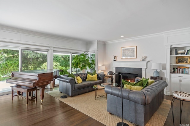 living room with crown molding and hardwood / wood-style flooring