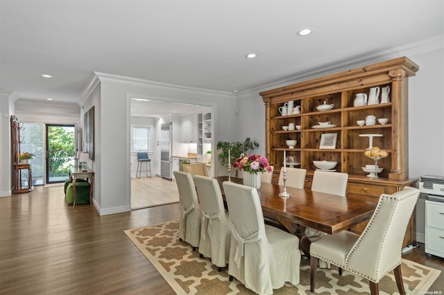 dining space featuring crown molding and wood-type flooring