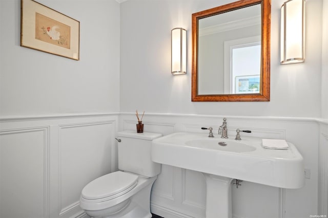 bathroom featuring ornamental molding, sink, and toilet