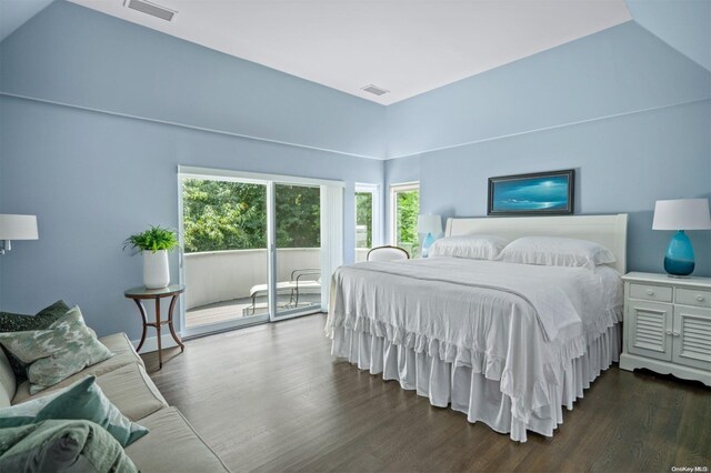 bedroom with dark hardwood / wood-style floors, vaulted ceiling, and access to outside