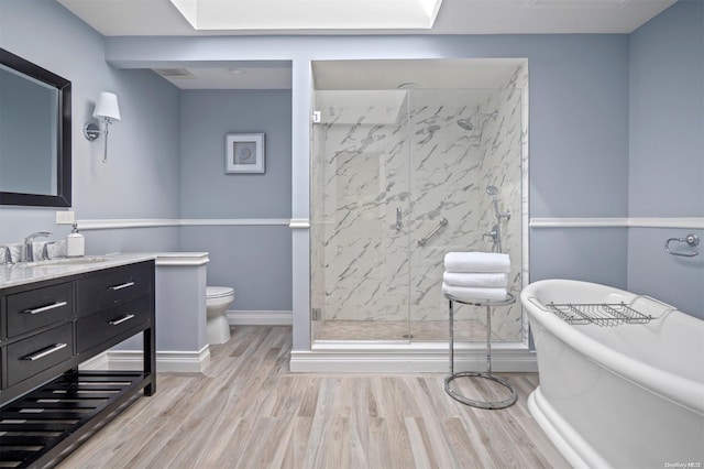 full bathroom featuring vanity, toilet, separate shower and tub, and hardwood / wood-style floors