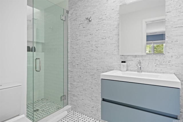 bathroom featuring vanity and a shower with shower door