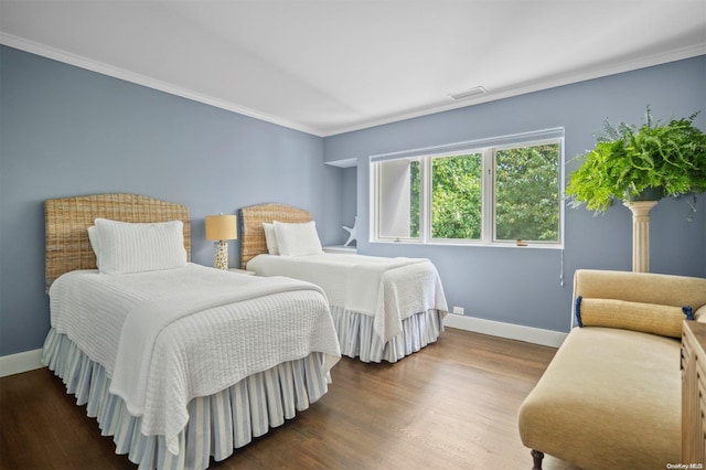 bedroom featuring crown molding and dark wood-type flooring