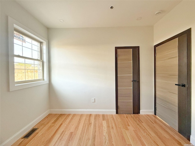 unfurnished bedroom with wood-type flooring