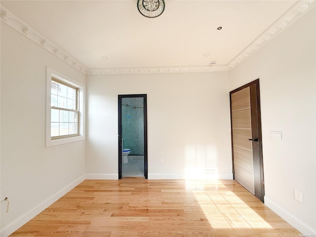 unfurnished room featuring light wood-type flooring and ornamental molding