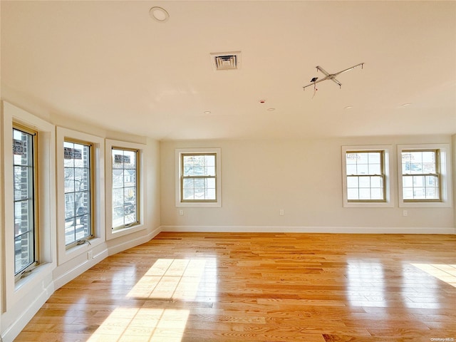 spare room with light hardwood / wood-style flooring