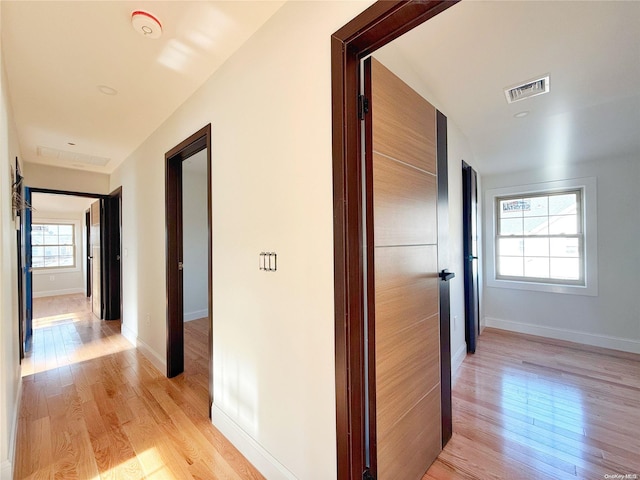 hall with light hardwood / wood-style flooring