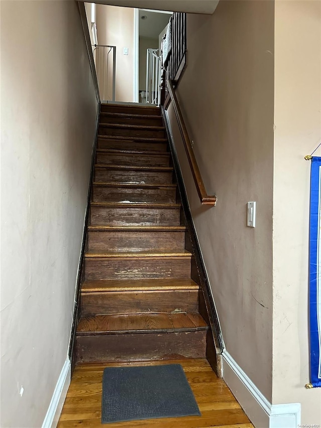 stairs with hardwood / wood-style flooring