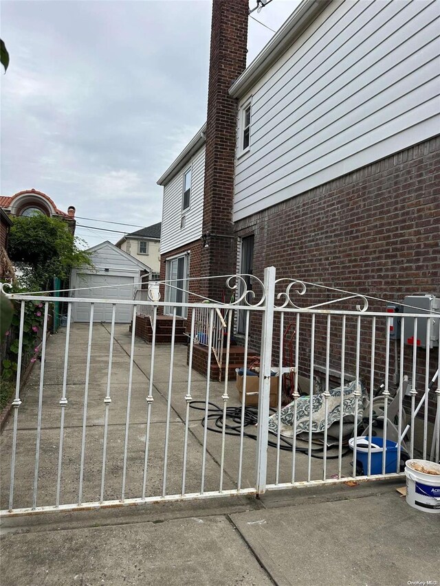 view of gate with an outbuilding